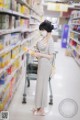 A woman wearing a face mask in a grocery store.