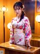 A woman in a kimono sitting at a table.