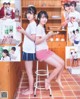 A couple of young women sitting on top of a stool.