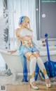 A woman sitting in a bathtub holding a sword.